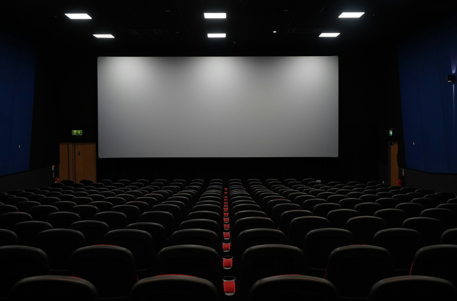 Empty cinema seats facing a dark screen
